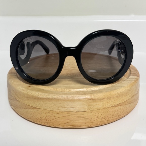 Black round Prada sunglassess with ornate arms. - Picture 2 of 5